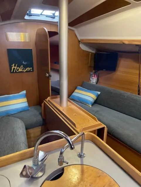 Slide: The Image of Interior of 1989 Beneteau First 285 sailboat with cozy seating and wooden finishes. - 10