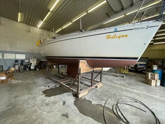 Slide: The Image of 1989 Beneteau First 285 sailboat in indoor storage, elevated on a stand. - 11