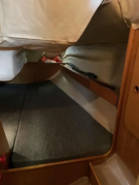 Slide: The Image of Interior cabin of 1989 Beneteau First 285 sailboat, featuring cozy sleeping area. - 4