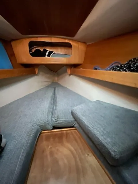 Slide: The Image of Cozy cabin interior of a 1989 Beneteau First 285 sailboat with cushioned seating. - 8