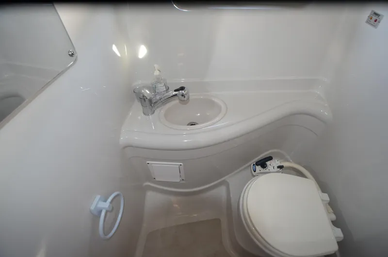 Slide: The Image of 2011 Crownline 280 CR boat bathroom with sink and toilet, compact and modern design. - 16