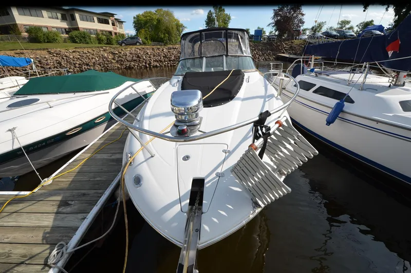 Slide: The Image of 2011 Crownline 280 CR boat docked at marina, surrounded by other vessels. - 19