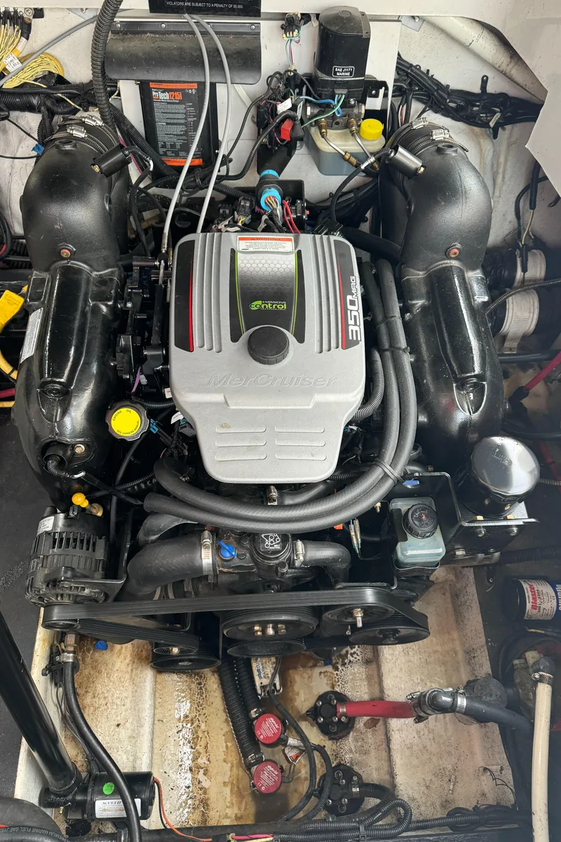 Slide: The Image of Engine of a 2011 Crownline 280 CR boat, showcasing detailed components and wiring. - 20