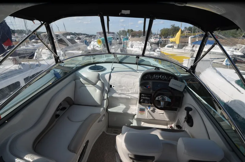 Slide: The Image of Interior view of 2011 Crownline 280 CR boat, featuring helm and seating area. - 4