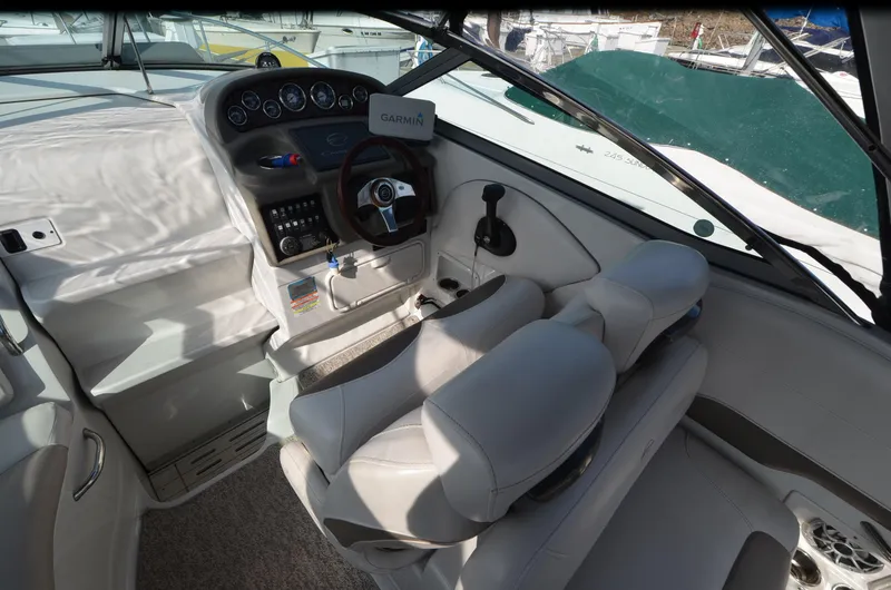 Slide: The Image of 2011 Crownline 280 CR boat cockpit with steering wheel and control panel. - 6