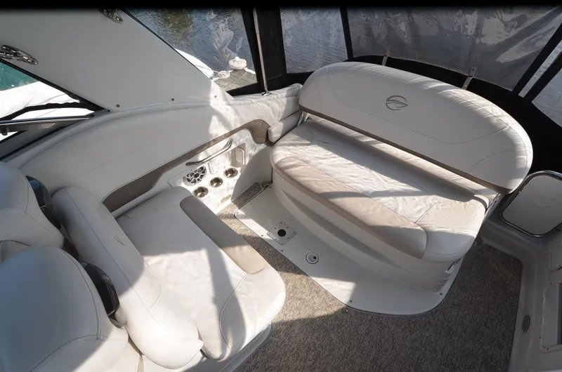 Slide: The Image of 2011 Crownline 280 CR boat interior with white seating and carpeted floor. - 9