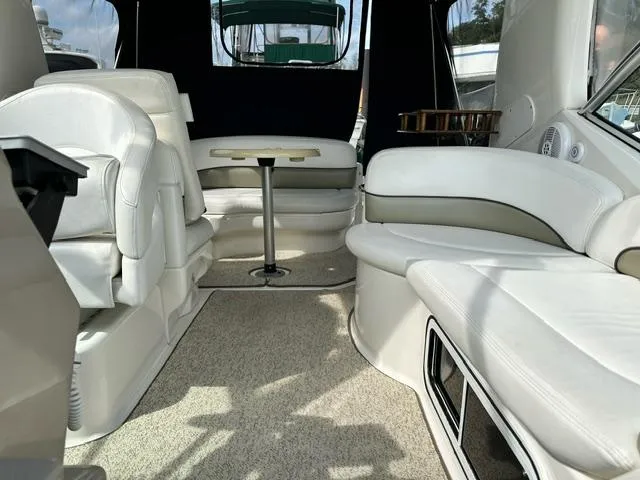 Slide: The Image of Interior of 2006 Sea Ray 260 Sundancer with white seating and table. - 10