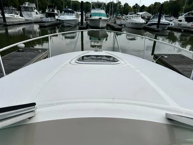 Slide: The Image of 2006 Sea Ray 260 Sundancer docked at marina, view from bow. - 11