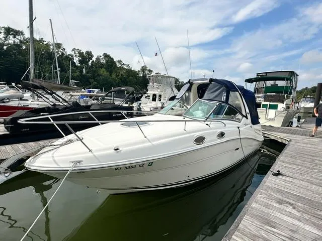 Slide: The Image of 2006 Sea Ray 260 Sundancer docked at marina under blue sky. - 3