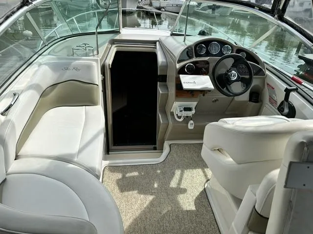 Slide: The Image of Interior of 2006 Sea Ray 260 Sundancer boat with steering wheel and seating. - 4