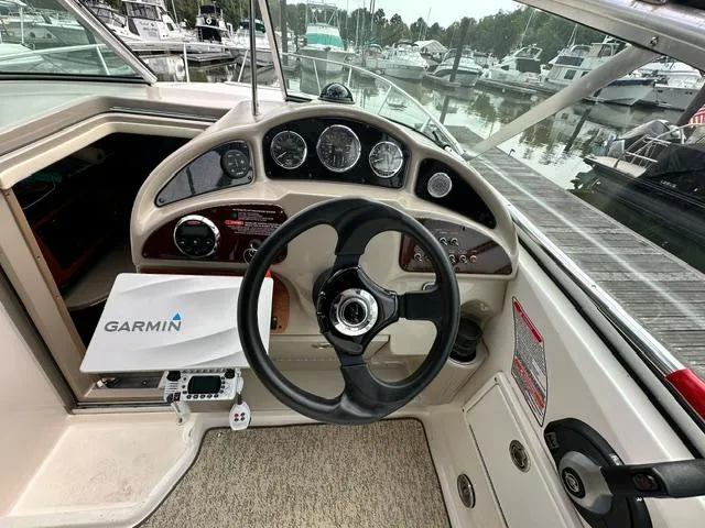 Slide: The Image of 2006 Sea Ray 260 Sundancer helm with Garmin navigation, docked at marina. - 6