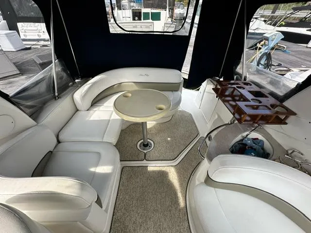 Slide: The Image of Interior of 2006 Sea Ray 260 Sundancer with white seating and table. - 8