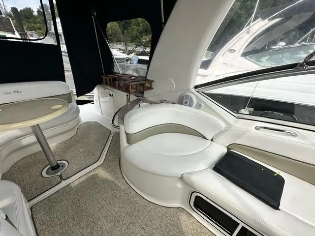 Slide: The Image of Interior of 2006 Sea Ray 260 Sundancer boat with white seating and table. - 9