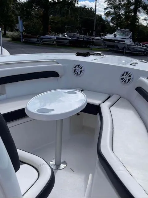 Slide: The Image of 2022 Tidewater 232 LXF boat interior with seating and table. - 5