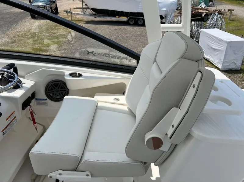 Slide: The Image of 2024 World Cat 260 DC-X boat interior with white seating and steering wheel. - 12