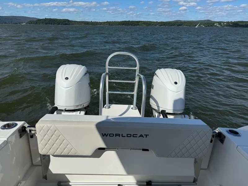 Slide: The Image of 2024 World Cat 260 DC-X boat with dual engines on a lake. - 8