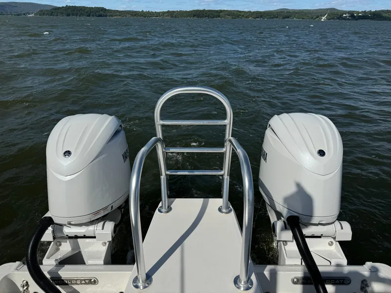 Slide: The Image of 2024 World Cat 260 DC-X boat engines on a lake with scenic background. - 9