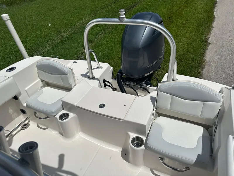 Slide: The Image of 2016 Robalo R200 Center Console boat interior with seating and engine. - 11