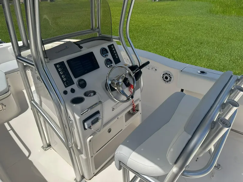 Slide: The Image of 2016 Robalo R200 Center Console boat interior with steering wheel and control panel. - 13