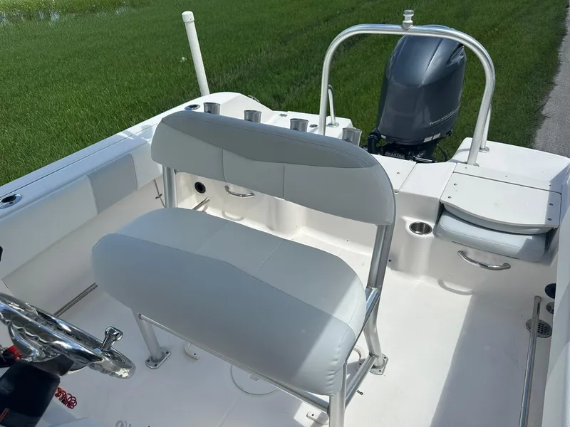 Slide: The Image of 2016 Robalo R200 Center Console boat interior with seating and outboard motor. - 14