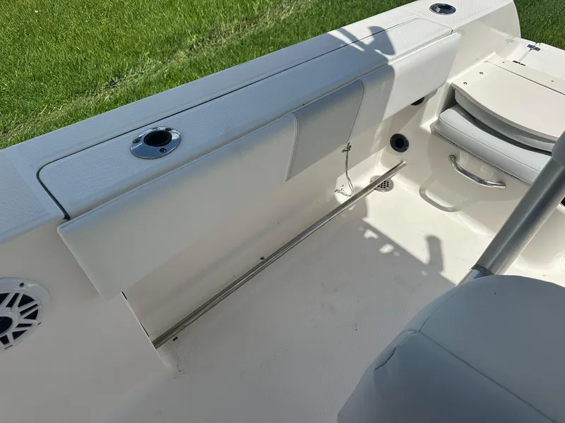 Slide: The Image of 2016 Robalo R200 Center Console boat interior with rod holders and seating. - 16