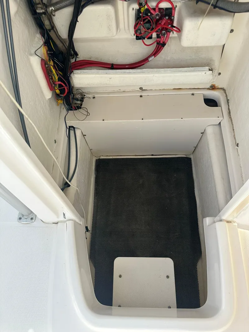 Slide: The Image of 2016 Robalo R200 Center Console boat interior with wiring and storage compartment. - 22