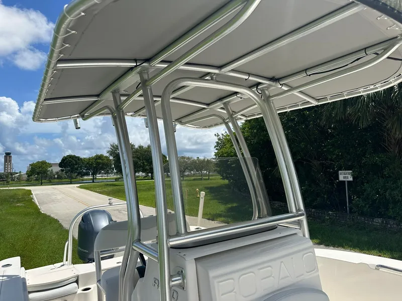Slide: The Image of 2016 Robalo R200 Center Console boat with T-top, parked outdoors. - 23