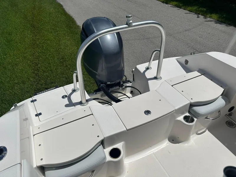 Slide: The Image of 2016 Robalo R200 Center Console boat with outboard motor, white seating, and cup holders. - 24