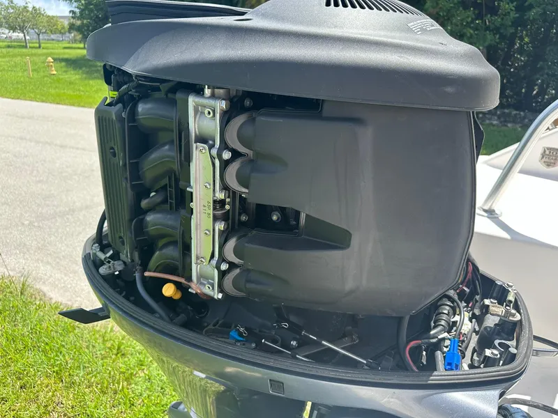 Slide: The Image of 2016 Robalo R200 Center Console outboard motor, detailed view, parked on grass. - 25