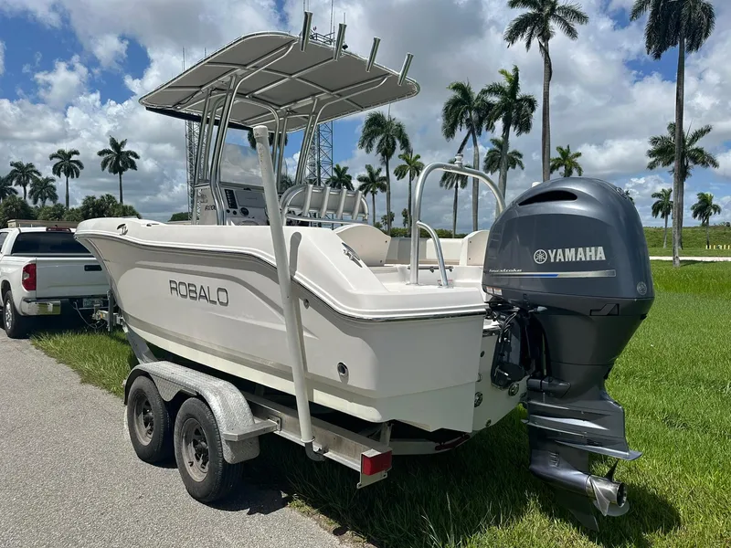 Slide: The Image of 2016 Robalo R200 Center Console boat with Yamaha engine on trailer, parked near palm trees. - 5
