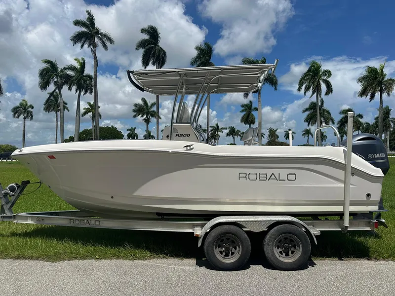 Slide: The Image of 2016 Robalo R200 Center Console boat on trailer, palm trees in background. - 6