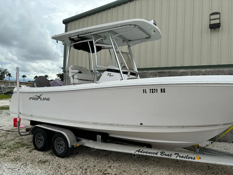 The Image of 2017 Pro-Line 23 Sport boat on trailer, parked outdoors. - 0