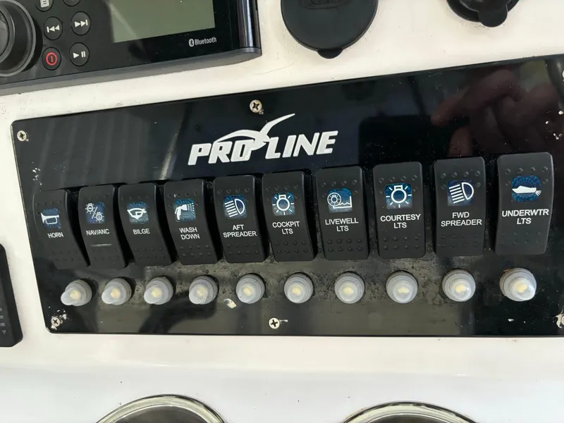 Slide: The Image of Control panel of a 2017 Pro-Line 23 Sport boat with labeled switches. - 11
