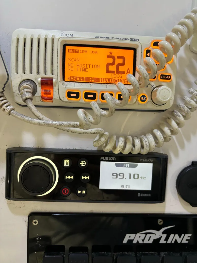 Slide: The Image of Pro-Line 23 Sport 2017 boat dashboard with Icom radio and Fusion stereo system. - 13