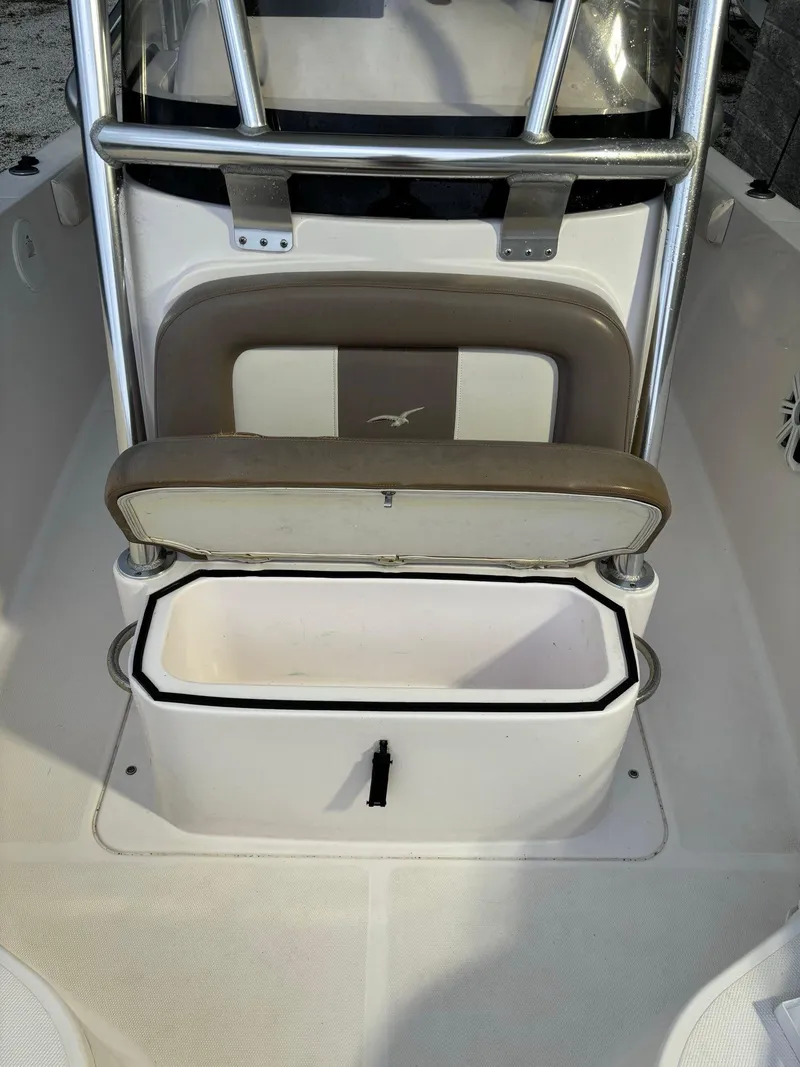 Slide: The Image of 2017 Pro-Line 23 Sport boat interior with open storage compartment. - 14