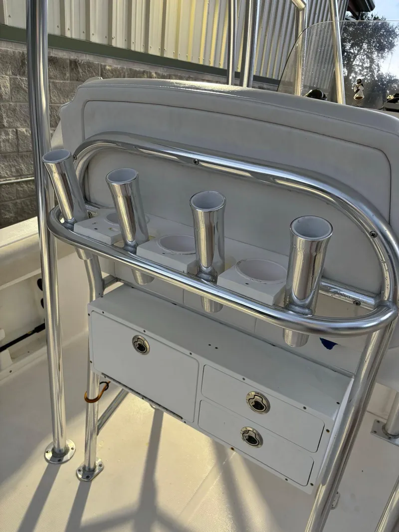 Slide: The Image of 2017 Pro-Line 23 Sport boat with rod holders and storage compartments. - 18