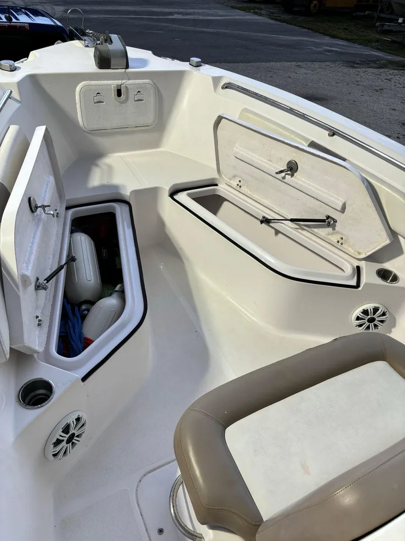 Slide: The Image of 2017 Pro-Line 23 Sport boat interior with open storage compartments. - 20