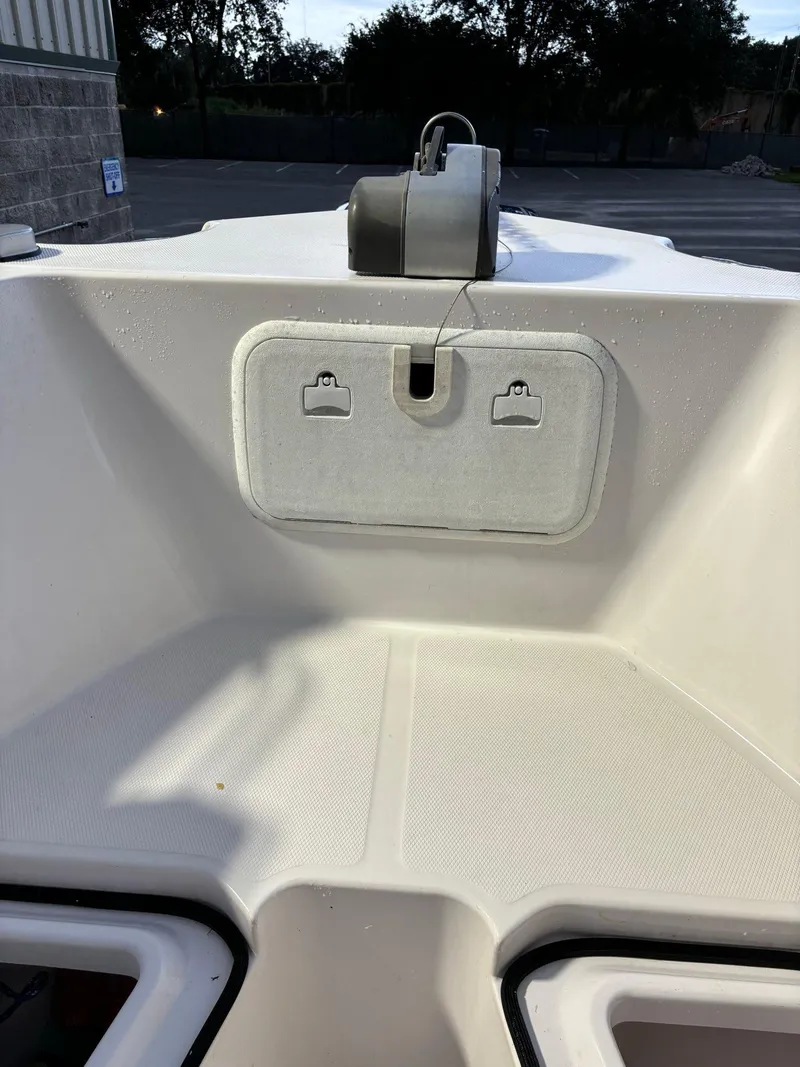 Slide: The Image of 2017 Pro-Line 23 Sport boat interior with storage compartment. - 23