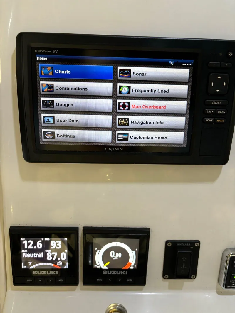 Slide: The Image of Garmin marine display on 2017 Pro-Line 23 Sport boat dashboard with Suzuki gauges. - 27