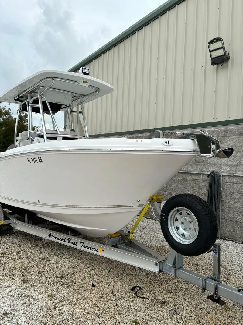 Slide: The Image of 2017 Pro-Line 23 Sport boat on trailer, parked outside a building. - 3