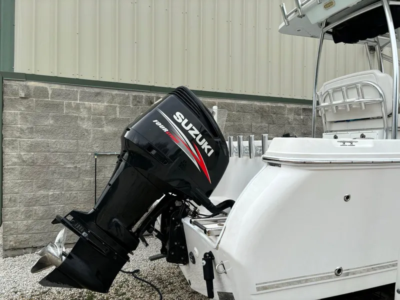 Slide: The Image of 2017 Pro-Line 23 Sport boat with Suzuki outboard motor, parked near a building. - 31