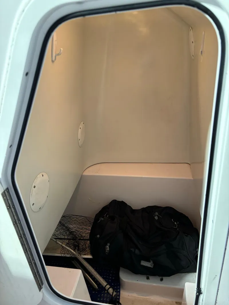 Slide: The Image of Interior cabin of 2017 Pro-Line 23 Sport boat with storage items. - 37
