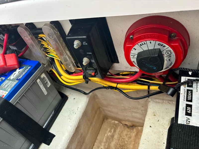 Slide: The Image of 2017 Pro-Line 23 Sport boat battery compartment with wiring and switch. - 38