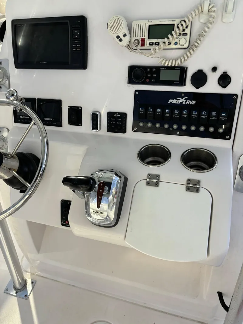 Slide: The Image of 2017 Pro-Line 23 Sport boat dashboard with steering wheel, controls, and electronics. - 7