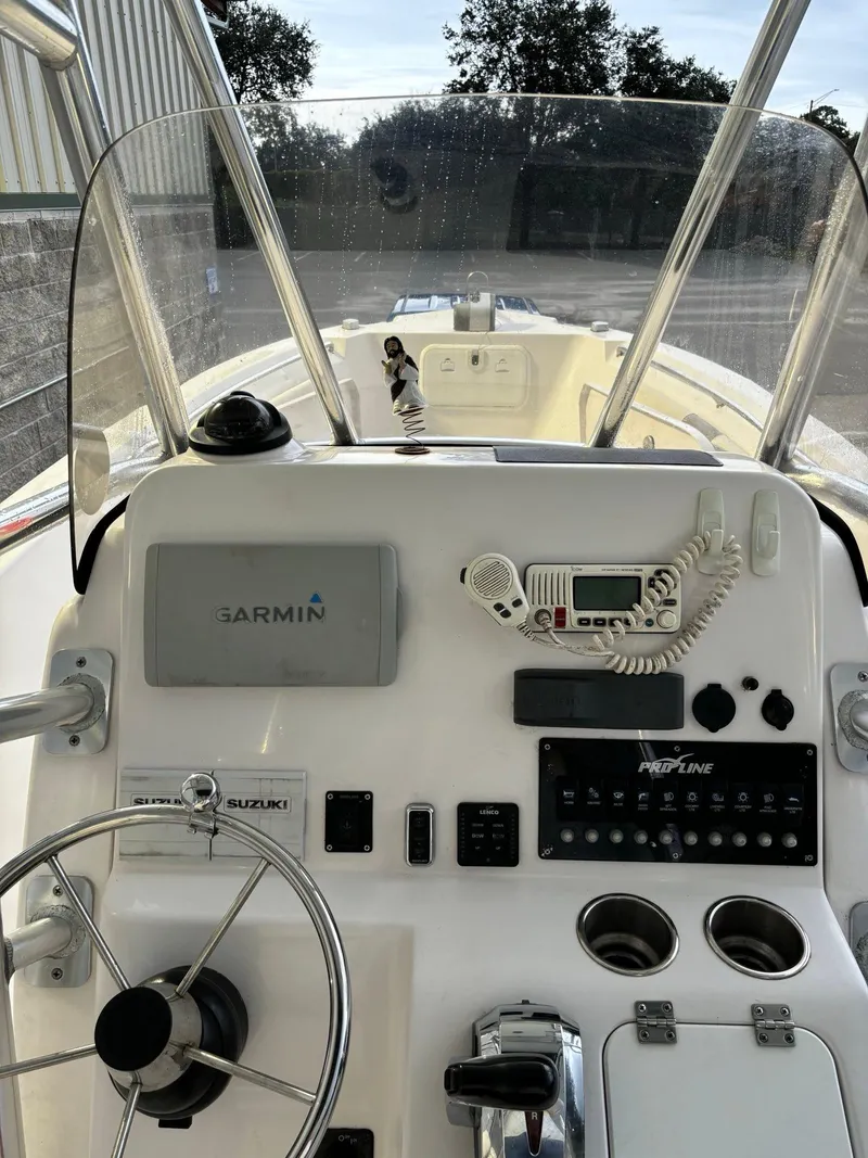 Slide: The Image of 2017 Pro-Line 23 Sport boat dashboard with Garmin navigation and Suzuki controls. - 8