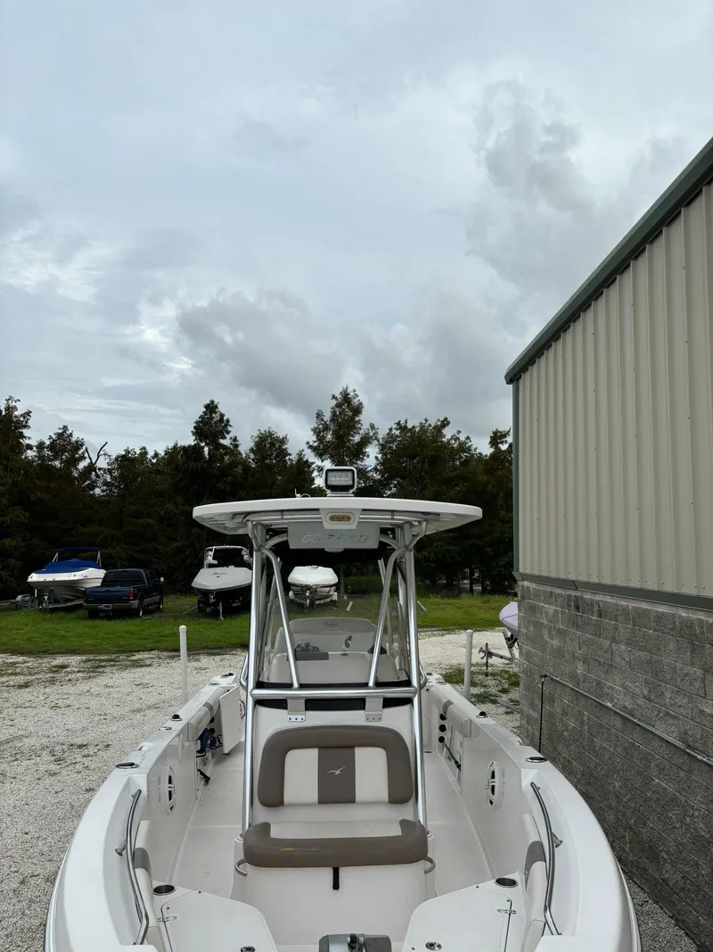 Slide: The Image of 2017 Pro-Line 23 Sport boat parked outdoors near a building. - 9