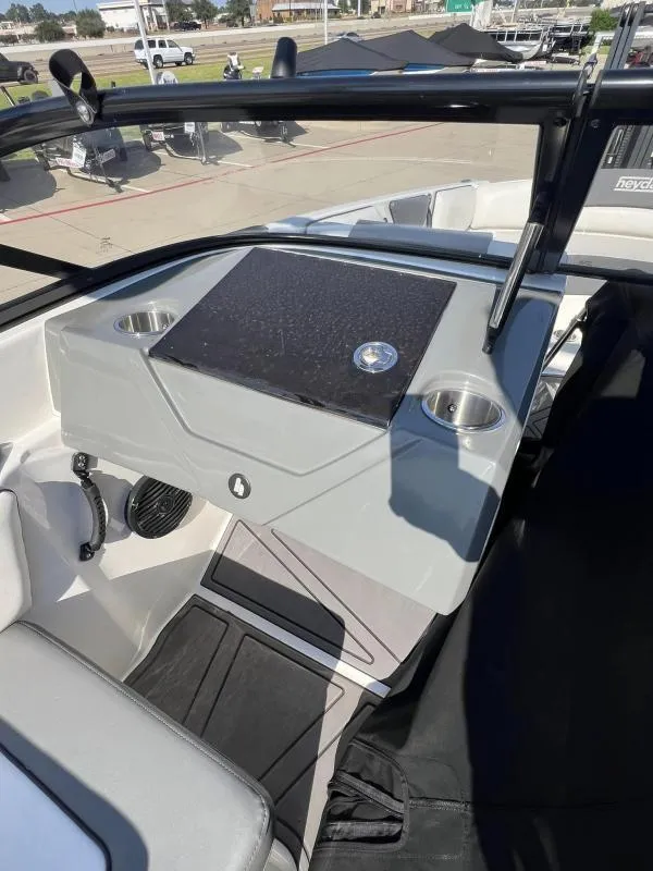 Slide: The Image of 2023 Heyday WTSurf boat dashboard with cup holders and control panel. - 13