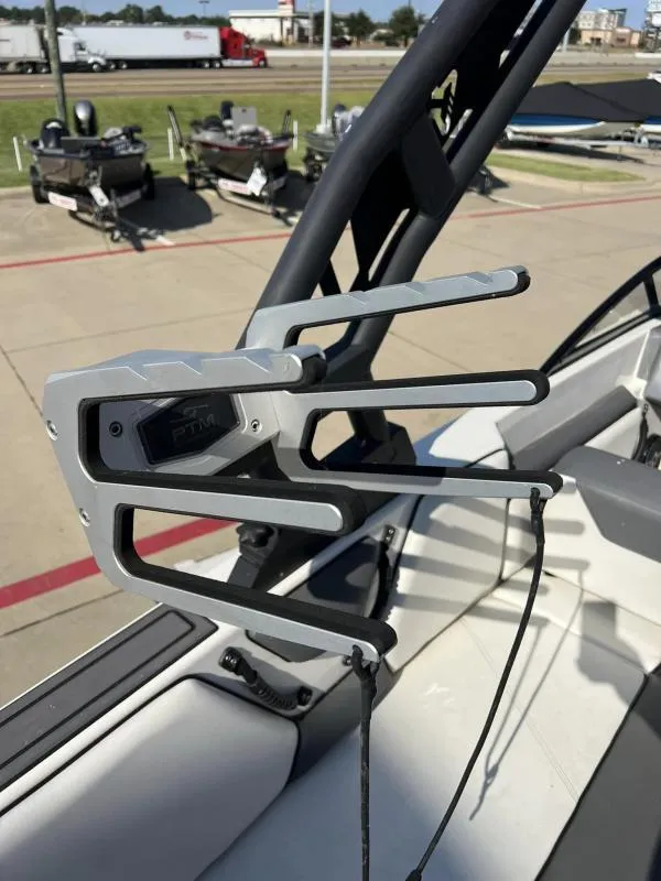 Slide: The Image of 2023 Heyday WTSurf boat with PTM mirror mount, docked with other boats in background. - 18