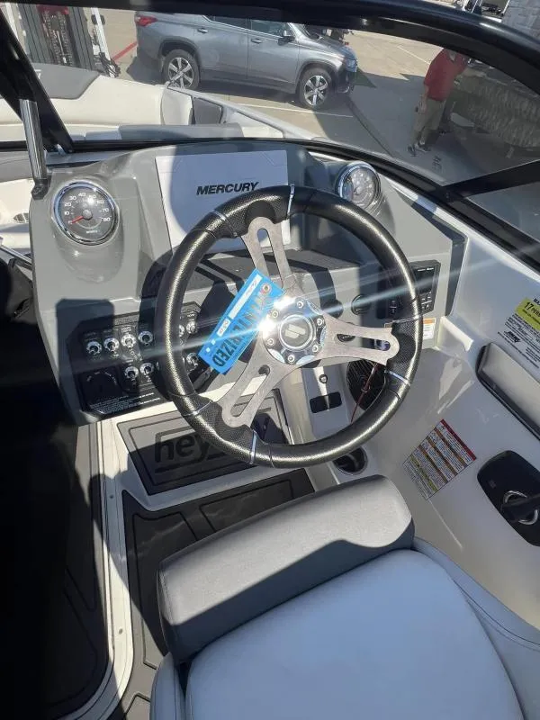 Slide: The Image of 2023 Heyday WTSurf boat dashboard with Mercury steering wheel and controls. - 9