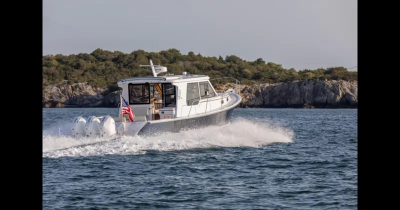 Slide: The Image of Luxurious interior of 2025 True North 39 Outboard Express yacht with elegant wood finishes. - 13